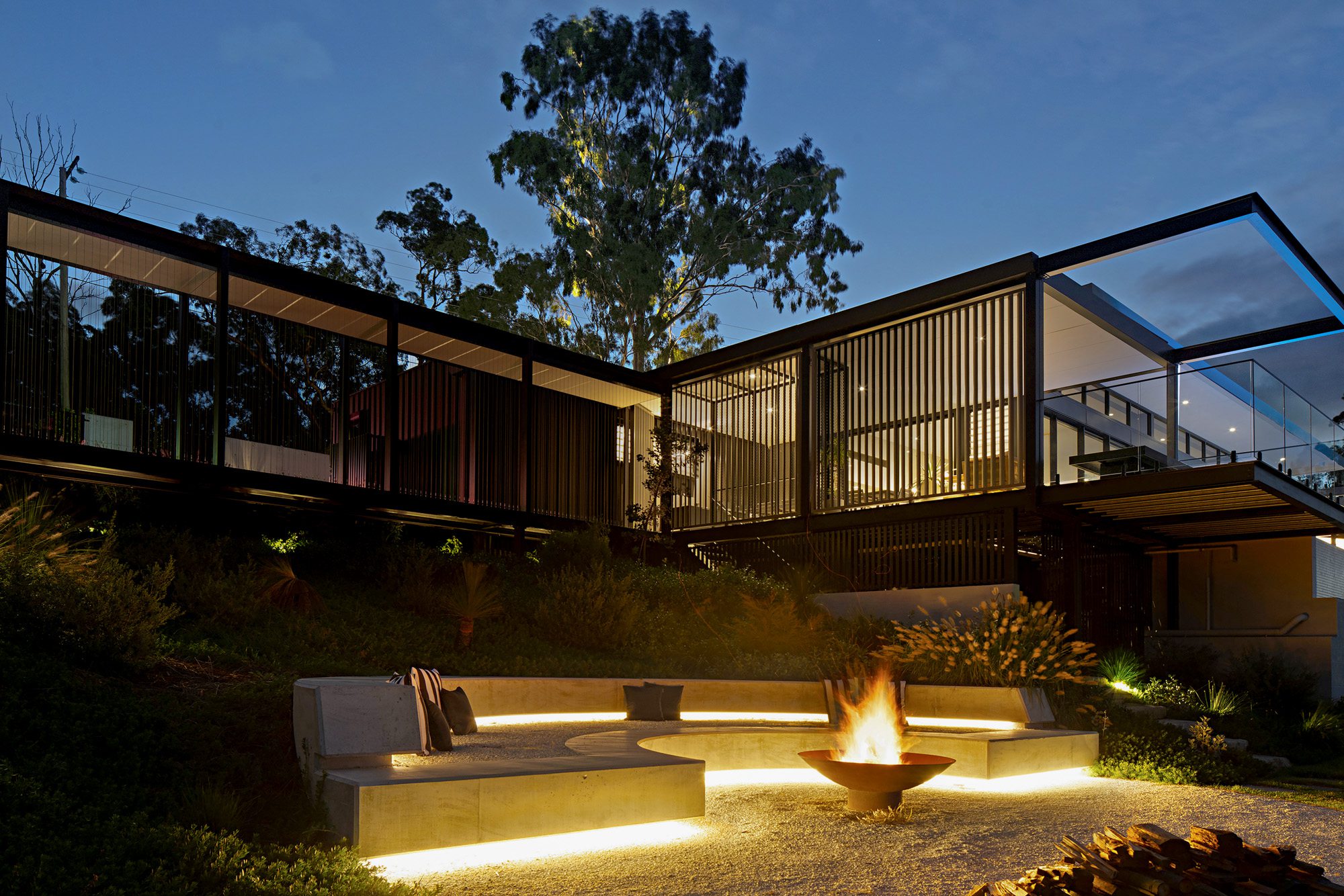 Panorama House Firepit at Night in Tallai – Cozy Outdoor Gathering by Zauss House Building Design